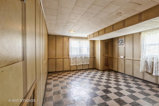 unfurnished room featuring tile patterned floors and plenty of natural light