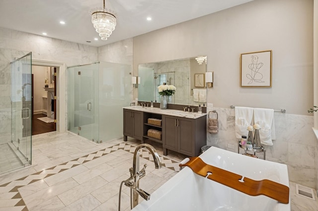 1242 N Astor St, Chicago, IL 60610 - bathroom with double vanity, a notable chandelier, a freestanding bath, a shower stall, and recessed lighting