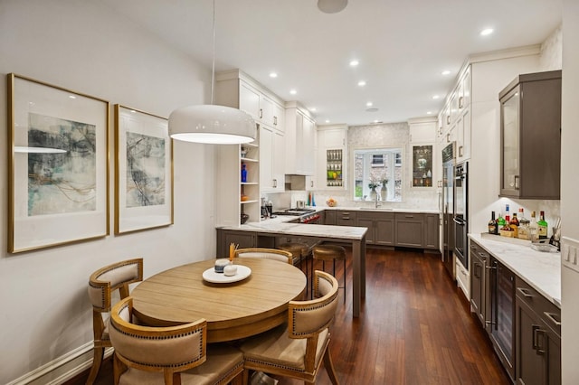 1242 N Astor St, Chicago, IL 60610 - kitchen featuring a peninsula, a sink, white cabinetry, dark wood-style floors, and recessed lighting