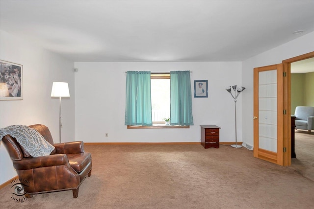living area with baseboards and carpet flooring