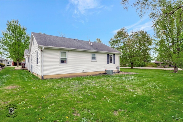 rear view of property with cooling unit and a lawn