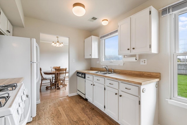 1005 Thomas Blvd, Mundelein, IL 60060 - kitchen with white appliances, white cabinetry, a sink, and light wood-style flooring