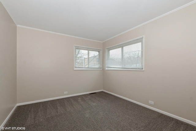 unfurnished room featuring crown molding, dark colored carpet, and baseboards
