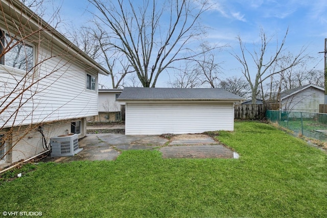 view of yard featuring an outbuilding, a patio, central air condition unit, and fence