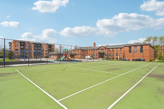 view of sport court with fence and playground community