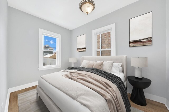 bedroom featuring wood finished floors and baseboards