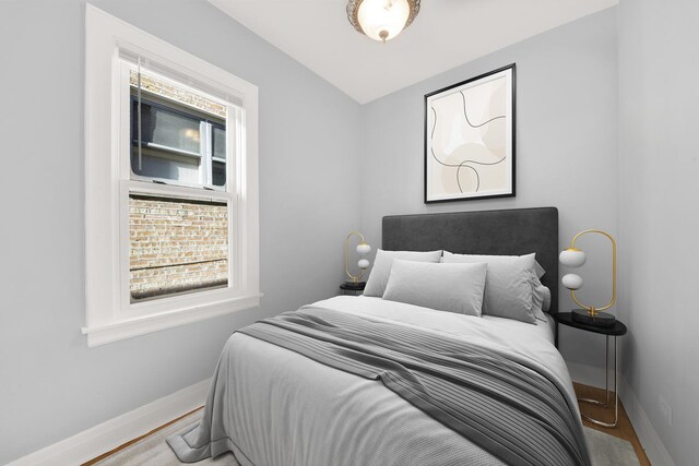 bedroom featuring wood finished floors and baseboards