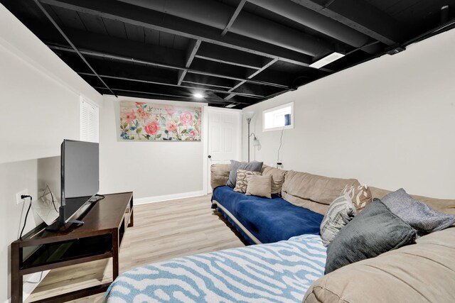 living area featuring baseboards and light wood-style floors
