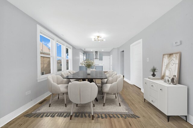 dining area with light wood finished floors, recessed lighting, visible vents, and baseboards