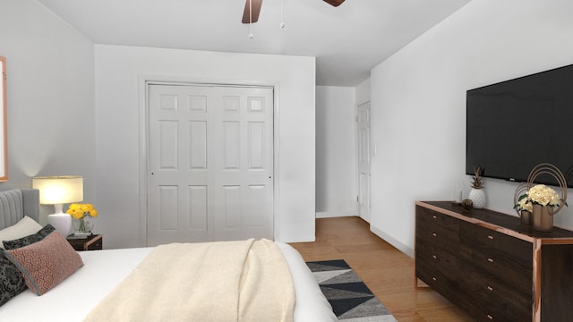 bedroom with light wood-style flooring, baseboards, a closet, and ceiling fan