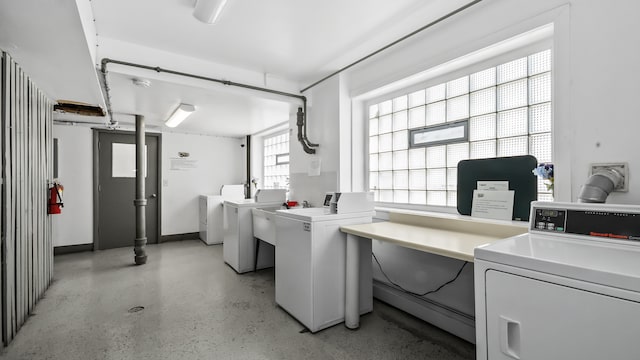 shared laundry area featuring washing machine and dryer