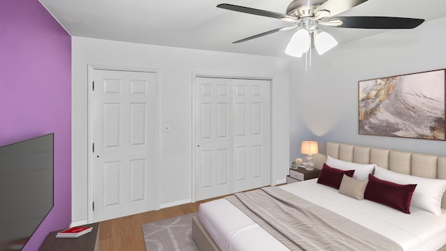 bedroom with a ceiling fan, wood finished floors, and a closet