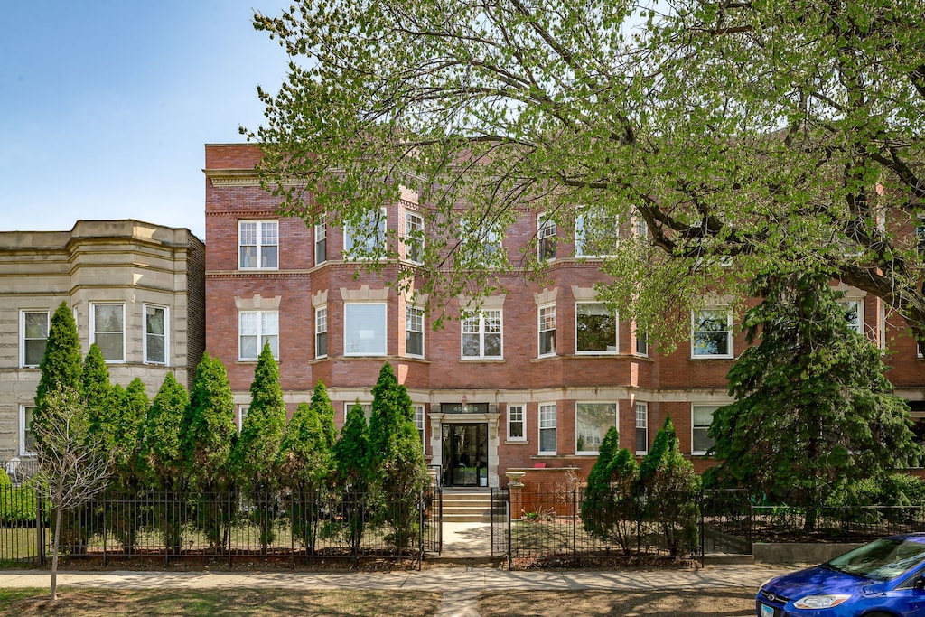 4519 N Ashland Ave Unit 2S, Chicago, IL 60640 - view of front of home featuring brick siding and fence private yard