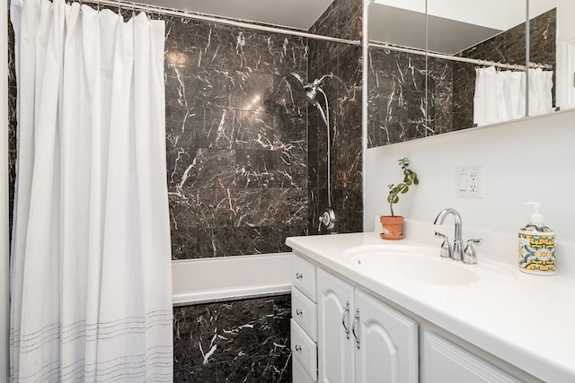 full bathroom with a combined bath / shower with marble appearance and vanity