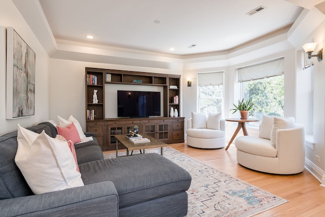 living room with light wood-type flooring, recessed lighting, and visible vents