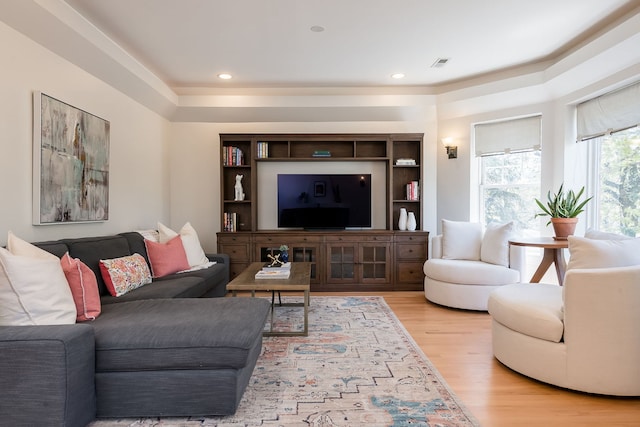 living room featuring light wood-type flooring, recessed lighting, and visible vents