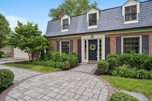 6N225 Circle Ave, Medinah, IL 60157 - view of front facade with a high end roof, brick siding, a chimney, and mansard roof