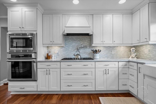 6N225 Circle Ave, Medinah, IL 60157 - kitchen featuring stainless steel appliances, custom range hood, white cabinets, dark wood-style flooring, and tasteful backsplash