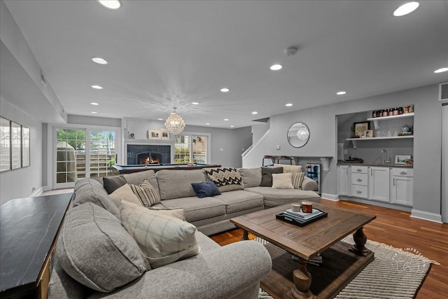 6N225 Circle Ave, Medinah, IL 60157 - living room featuring recessed lighting, a lit fireplace, wet bar, dark wood-type flooring, and baseboards