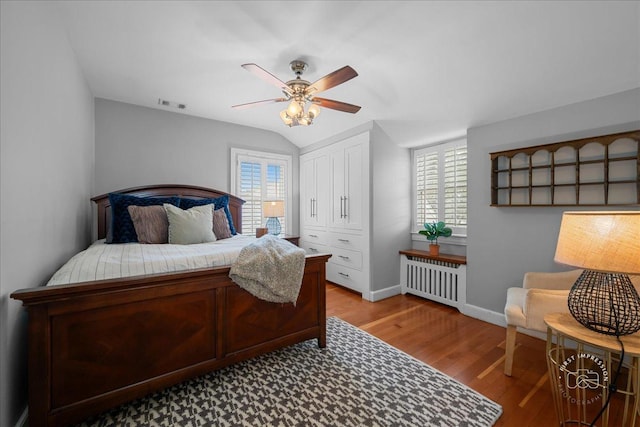 6N225 Circle Ave, Medinah, IL 60157 - bedroom with radiator heating unit, multiple windows, light wood-style flooring, baseboards, and vaulted ceiling