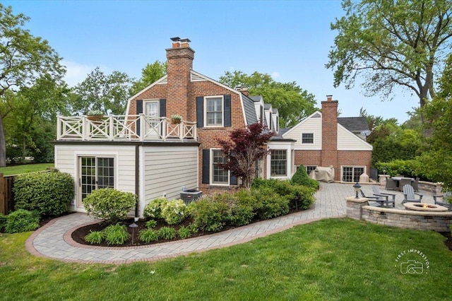 6N225 Circle Ave, Medinah, IL 60157 - back of house featuring a fire pit, a balcony, a chimney, a yard, and a patio