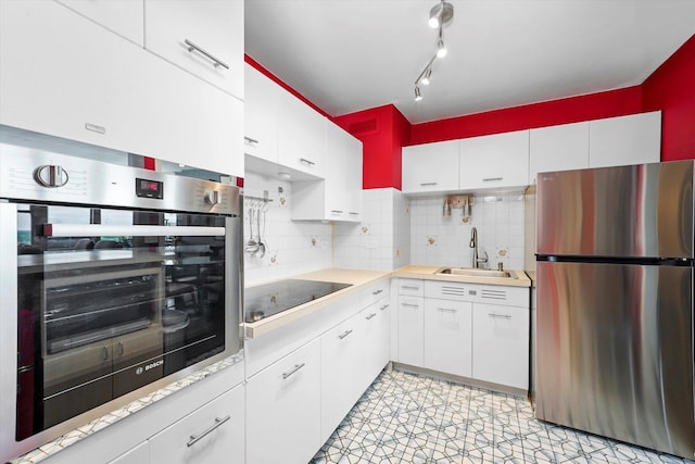 6301 N Sheridan Rd Unit 20J, Chicago, IL 60660 - kitchen with stainless steel appliances, a sink, light countertops, and white cabinetry