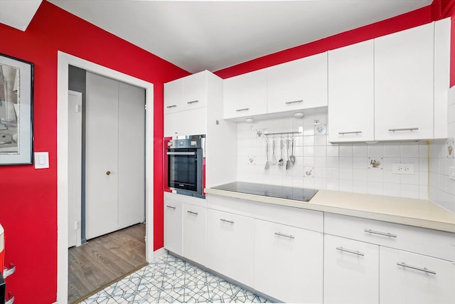6301 N Sheridan Rd Unit 20J, Chicago, IL 60660 - kitchen featuring stainless steel oven, black electric cooktop, light countertops, and white cabinets