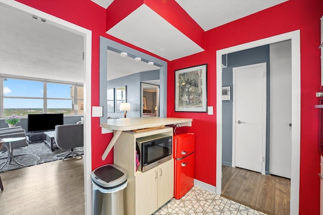 6301 N Sheridan Rd Unit 20J, Chicago, IL 60660 - kitchen featuring built in microwave, a desk, light wood-style flooring, and baseboards