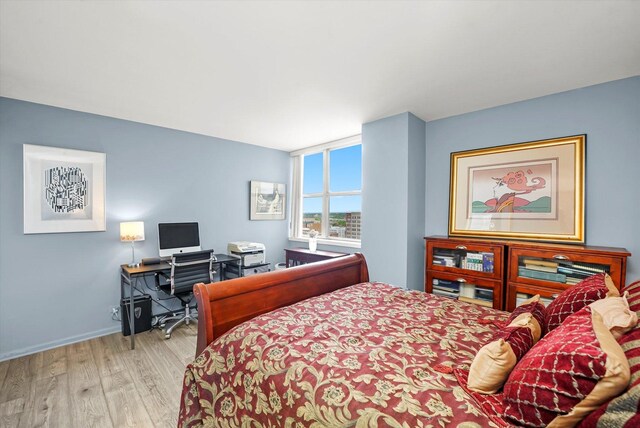6301 N Sheridan Rd Unit 20J, Chicago, IL 60660 - bedroom featuring wood finished floors, a desk, and baseboards