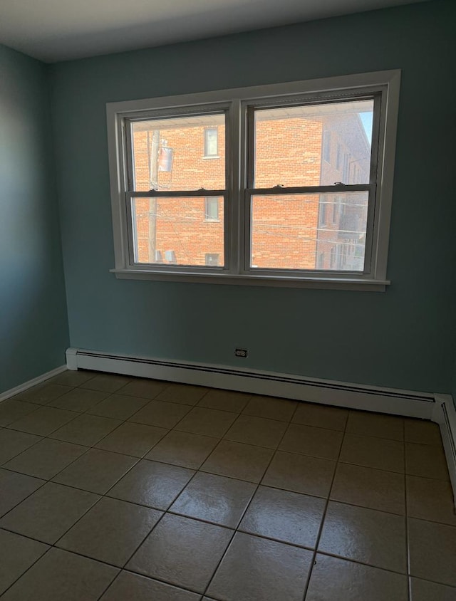 7324 W 80th St, Bridgeview, IL 60455 - tiled empty room featuring baseboards, a baseboard heating unit, and a wealth of natural light