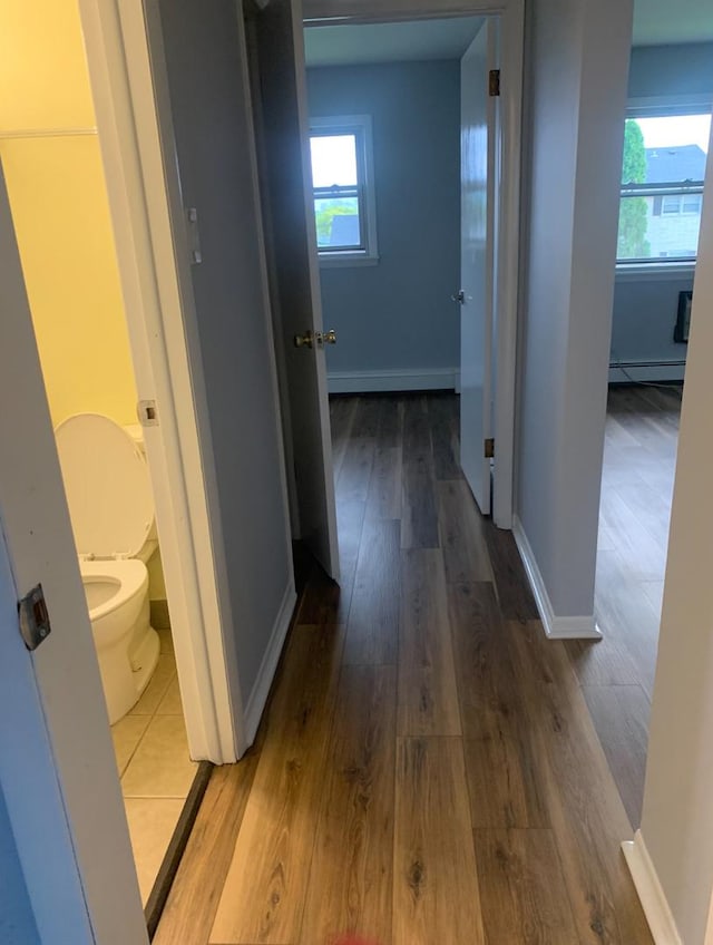 7324 W 80th St, Bridgeview, IL 60455 - hallway with baseboards, a baseboard radiator, and wood finished floors