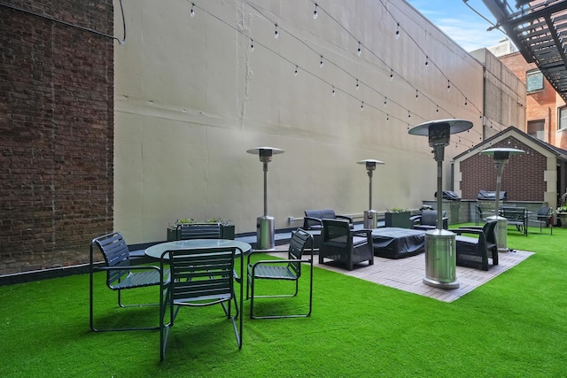 view of property's community with outdoor lounge area and a lawn