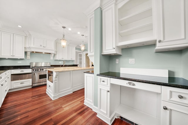 kitchen with dark wood-type flooring, stainless steel appliances, a warming drawer, and white cabinets