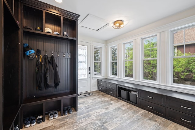 mudroom featuring wood finished floors and attic access