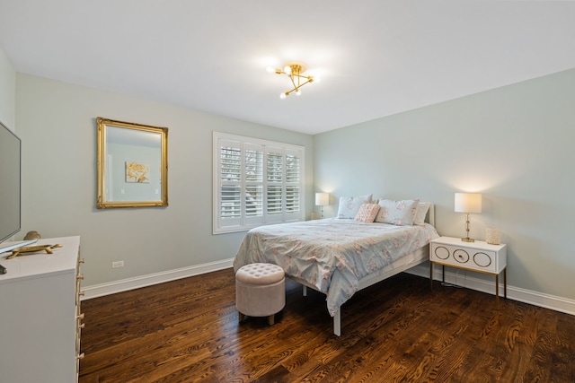 bedroom featuring wood finished floors and baseboards