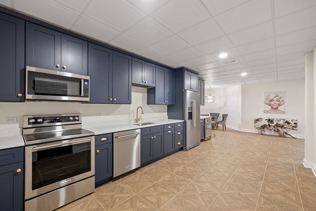 kitchen featuring appliances with stainless steel finishes, a sink, light countertops, baseboards, and recessed lighting