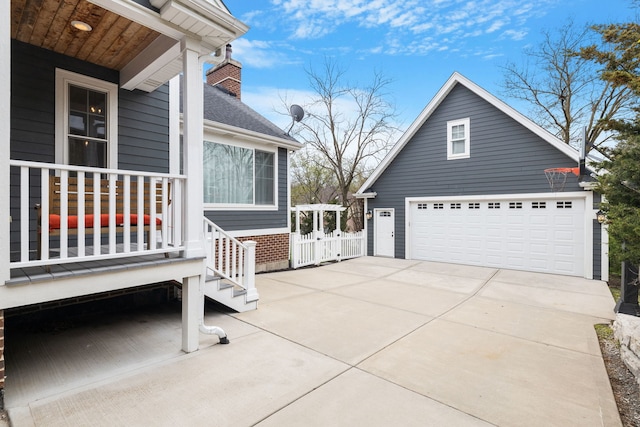view of home's exterior featuring a chimney, a garage, brick siding, and covered porch