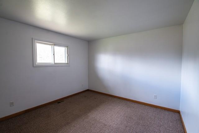 34830 47th St, Burlington, WI 53105 - empty room featuring baseboards and carpet flooring