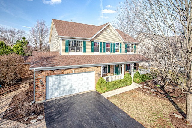12941 Grande Poplar Cir, Plainfield, IL 60585 - traditional-style house with driveway, roof with shingles, covered porch, brick siding, and a garage