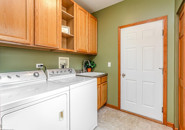 12941 Grande Poplar Cir, Plainfield, IL 60585 - clothes washing area featuring baseboards, cabinet space, washing machine and clothes dryer, and a sink