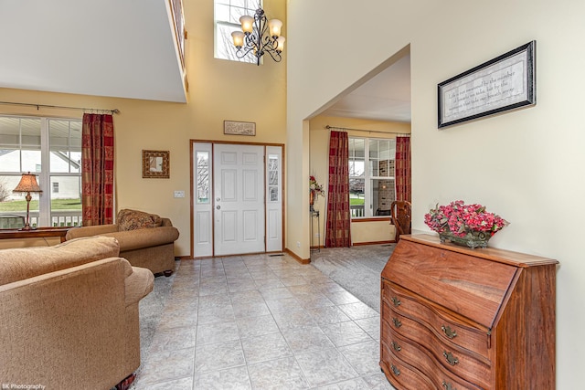 12941 Grande Poplar Cir, Plainfield, IL 60585 - entrance foyer with light tile patterned floors, a high ceiling, a chandelier, and baseboards