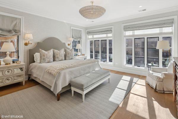 bedroom featuring wood finished floors, crown molding, and visible vents