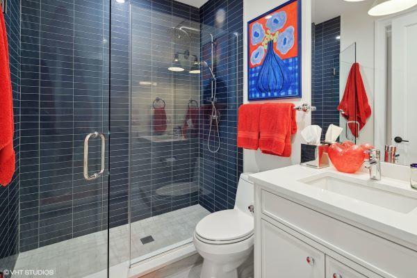 full bath with toilet, a stall shower, and vanity