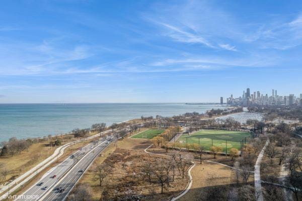 birds eye view of property featuring a water view and a city view