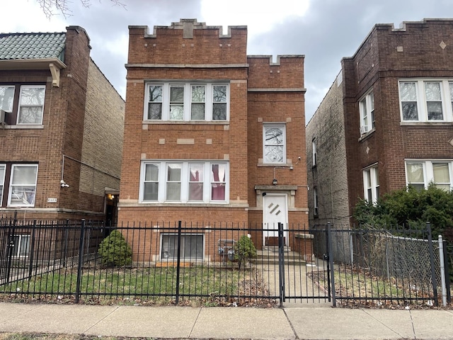 exterior space with a fenced front yard and brick siding