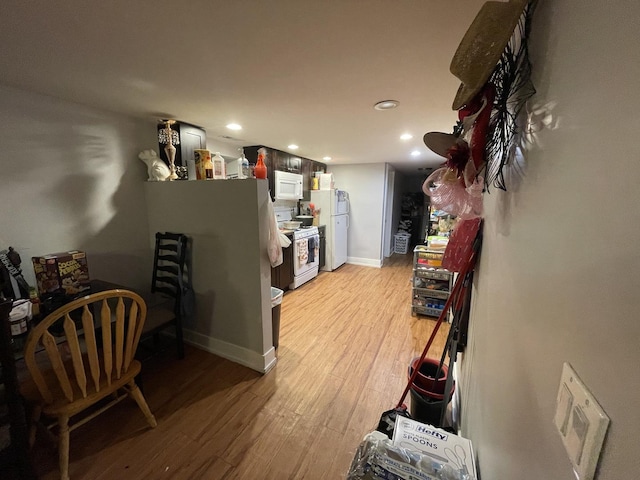 interior space featuring light wood-style floors, baseboards, and recessed lighting
