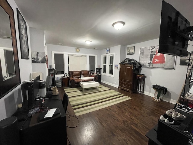 living area with baseboards, french doors, and wood finished floors