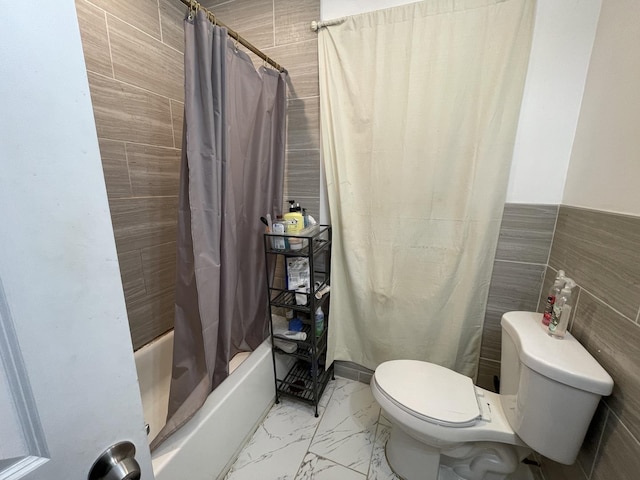 bathroom featuring toilet, shower / bath combo with shower curtain, and marble finish floor