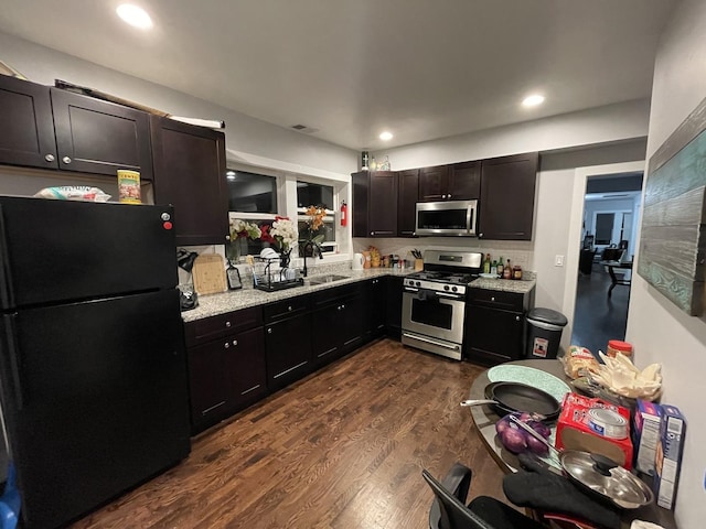 kitchen featuring light stone countertops, recessed lighting, visible vents, appliances with stainless steel finishes, and dark wood-style floors