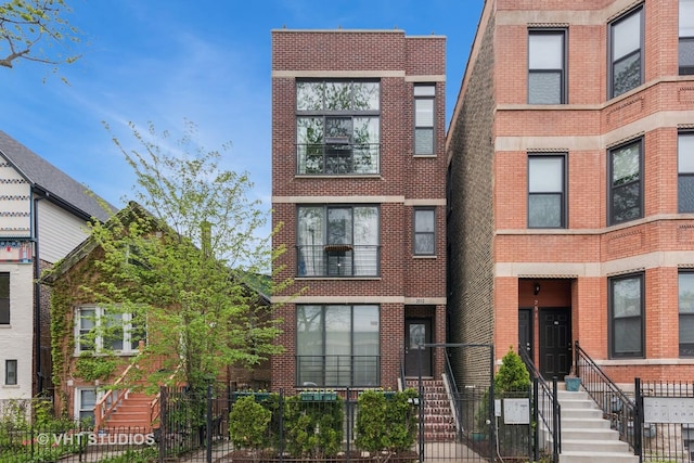 2512 W Thomas St Unit 3, Chicago, IL 60622 - view of property with brick siding and a fenced front yard
